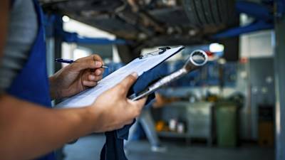 car mechanic with a maintenance schedule